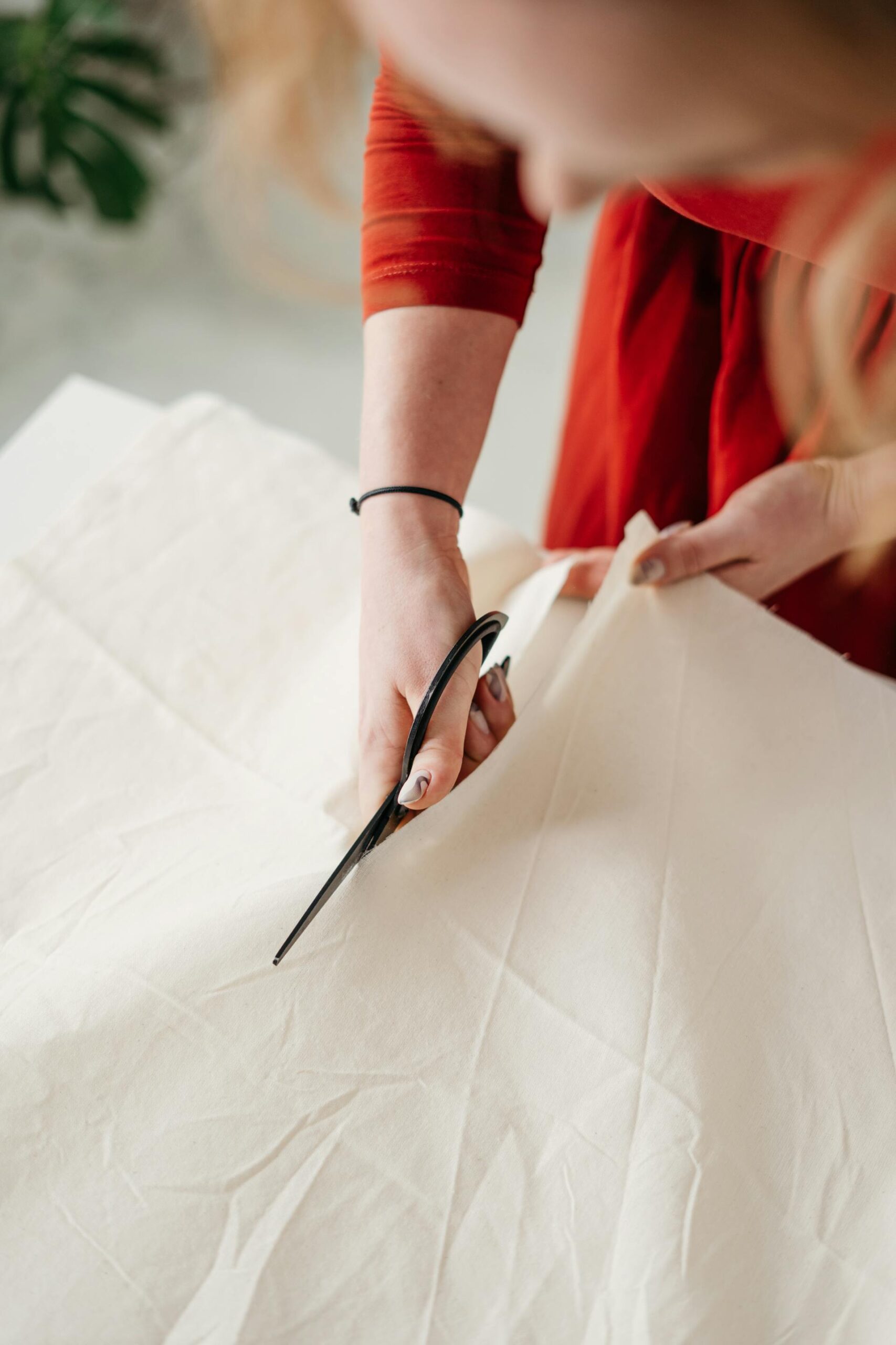 A woman cutting a dress | Source: Pexels